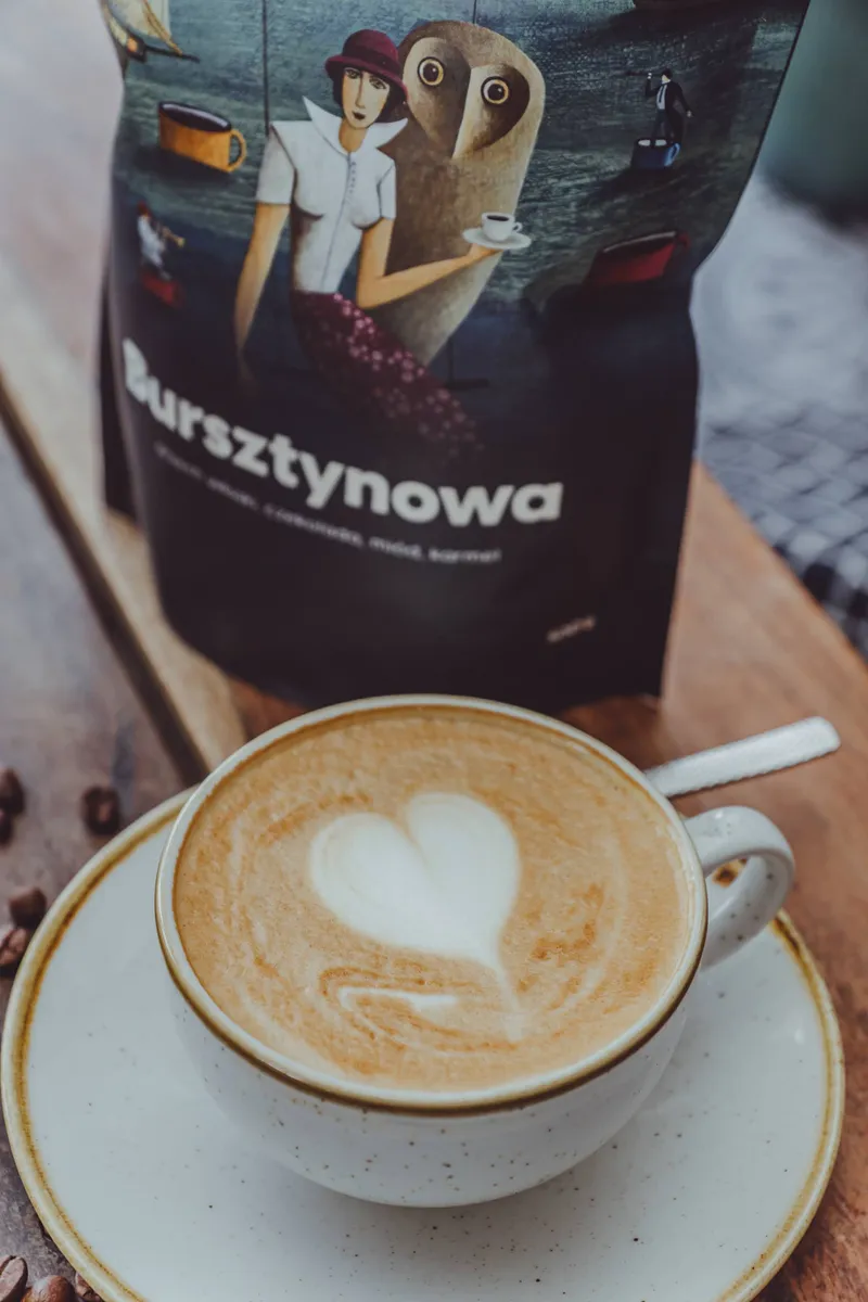 Cappuccino beside a pack of Bursztynowa coffee