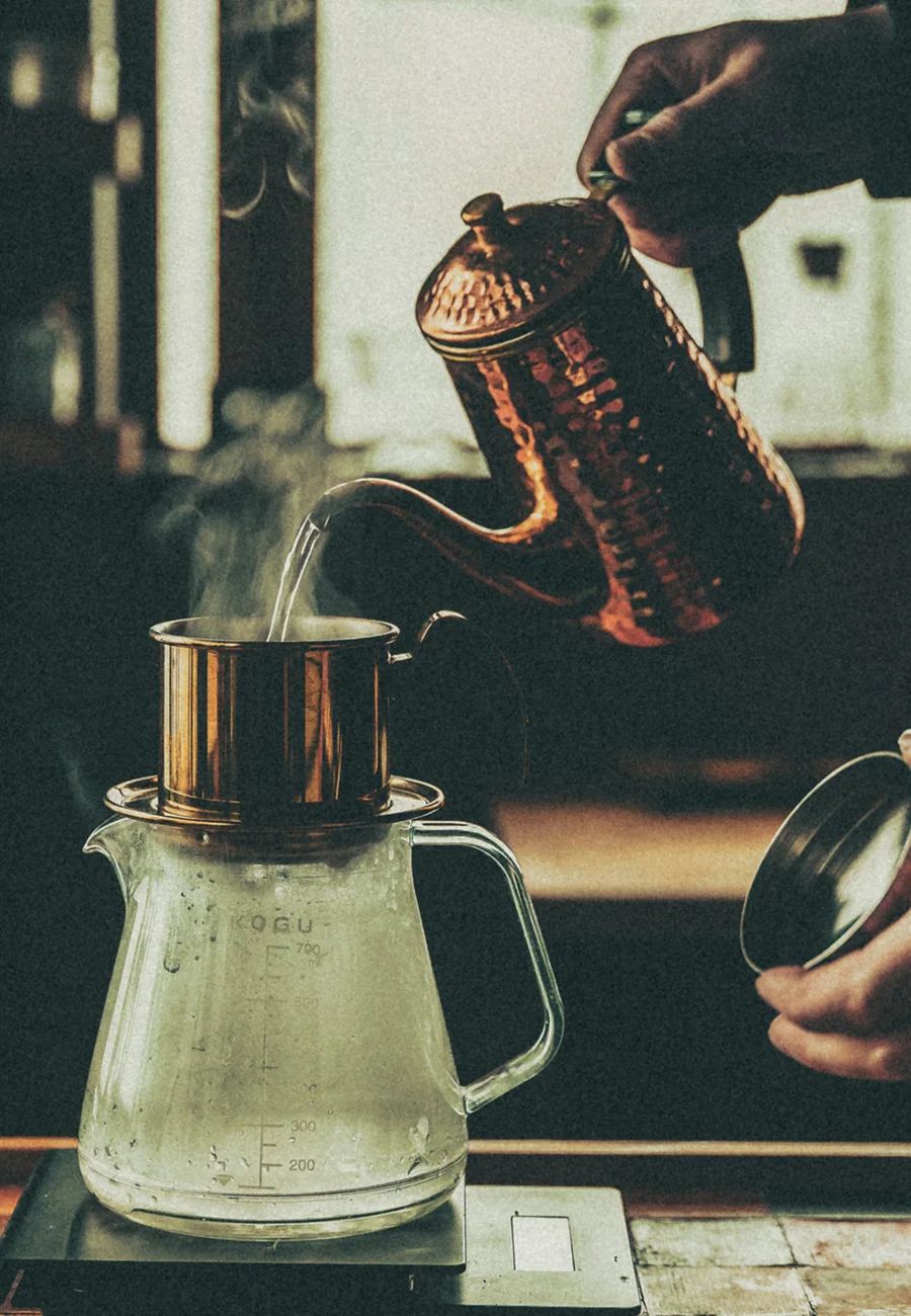 Pour-over coffee preparation in a photograph from the current brand website